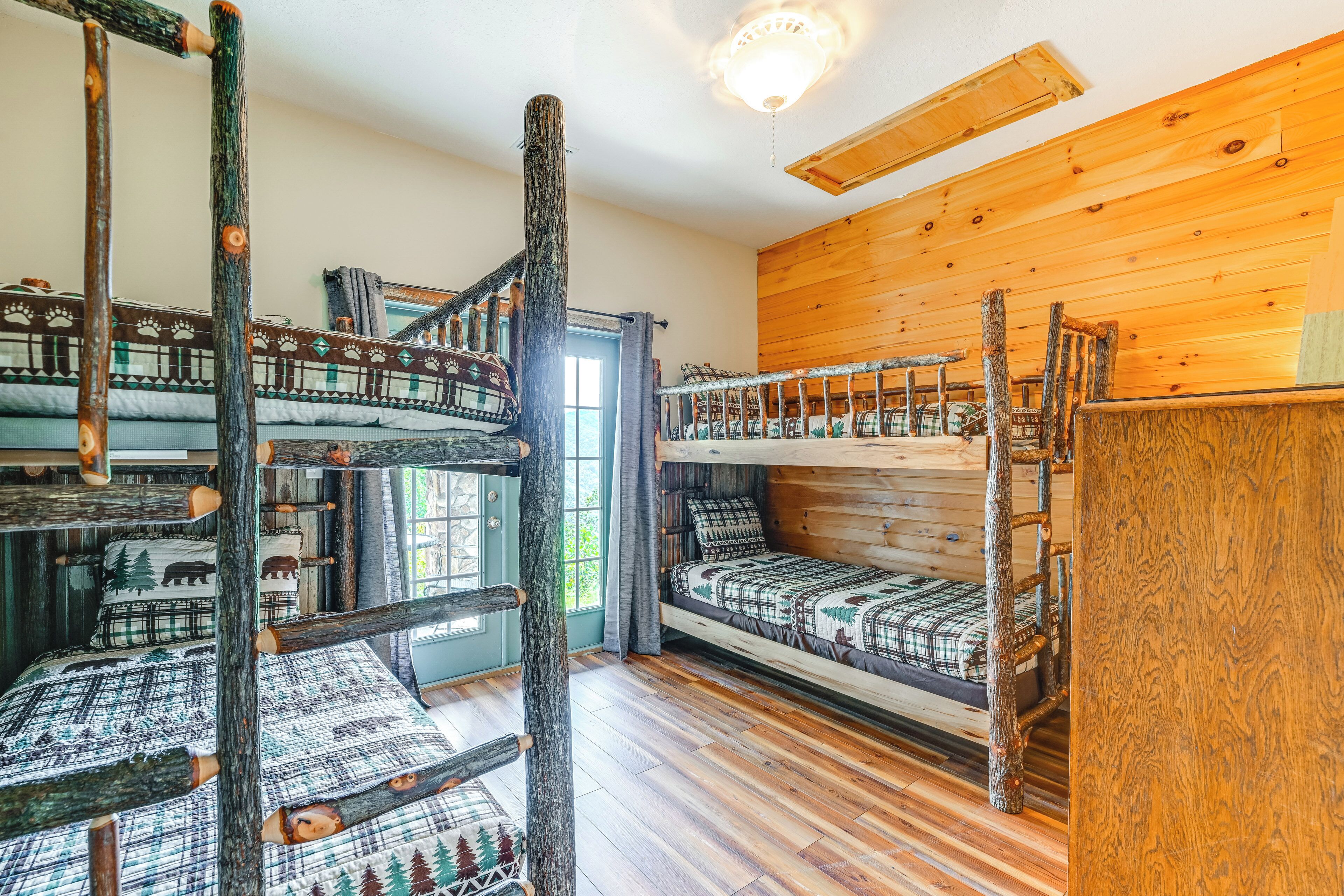 A cabin with bunk beds, wooden walls, and a rustic interior.