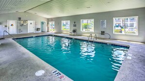 An indoor swimming pool with clear water, a lifeguard station, and a covered area with windows. - Screened Porch & Community Perks: Myrtle Beach Gem (Myrtle Beach)