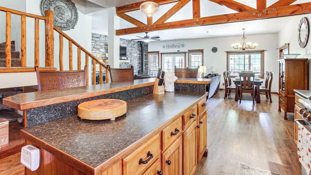 A spacious kitchen with granite countertops, wooden cabinets, and a large island. - Idaho Family Home ~ 11 Mi to Lake Pend Oreille (Cocolalla)
