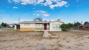 A single-story house with a front porch, a garage, and a small yard. - Carlsbad Home ~ 22 Mi to Nat'l Park! (Carlsbad)