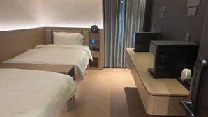 A hotel room with two beds, a desk with a computer, and a window with curtains. - Youjian Hotel (Harbin Acheng Impression City) (Harbin)