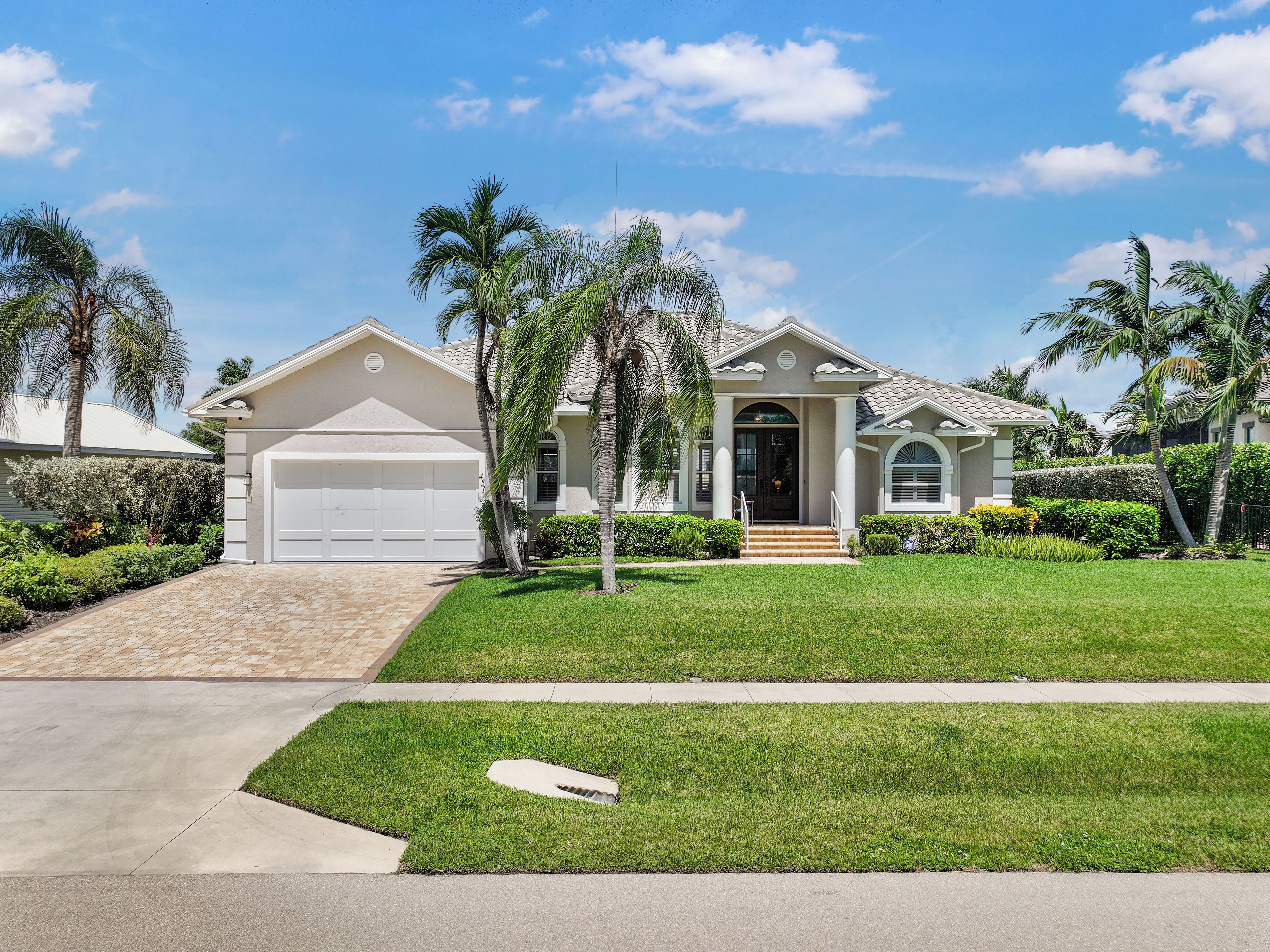 A single-story house with a garage, a front porch, and a well-maintained lawn.