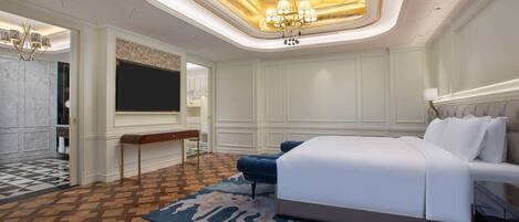 A modern bedroom with a large bed, a desk, and a chandelier.