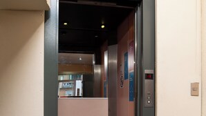 An elevator with a metallic interior and a control panel on the right. - HOTEL TERRANORT (Iquique)