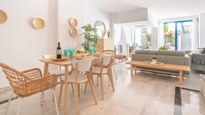 A modern living room with a dining area, featuring a sofa, a coffee table, and a dining table with chairs. - Marbella House Gf30 in Marbella (Marbella)