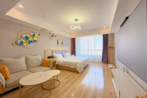 A modern hotel room with a bed, sofa, and a small table. - Qingzhu·Youyang Hotel (Guang'an Street Museum Metro Station) (Shijiazhuang)