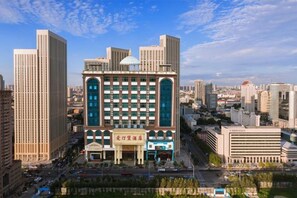 A multi-story hotel with a central atrium, surrounded by high-rise buildings. - Shenzhen Aitingbao Hotel (Shenzhen)