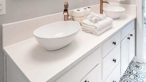 A modern bathroom with a large mirror, two sinks, and a wooden vanity. - Mad Hatter 2BR, Sauna | Price Negotiable, Send DM (Charlotte)
