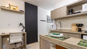 A modern kitchen with a countertop, a chair, a sink, and a coffee maker. - In Front of the Underground and 8 Minutes From the Beach Sf228 (Rio de Janeiro)