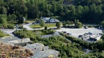 A mountainous landscape with a parking area and buildings.