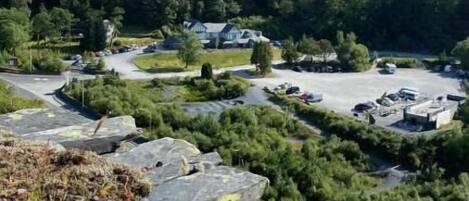 A mountainous landscape with a parking area and buildings.