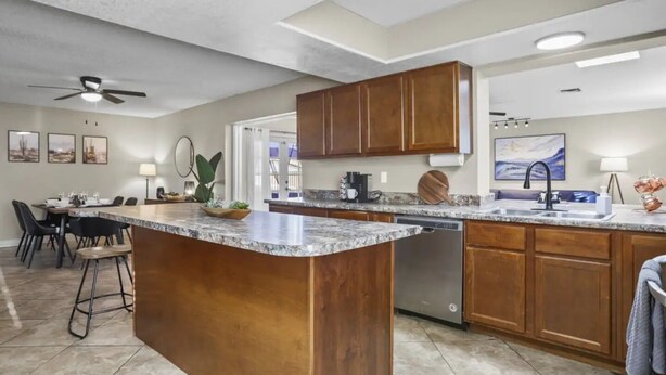A spacious kitchen with granite countertops, wooden cabinets, and a central island. - Large Pool, Near State Farm STDM and Many Entertainment Districts! (Peoria)