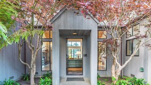A modern house with a wooden exterior, a front door, and a small porch area. - Soak in Ocean Views at Blair w/ Hot Tub! (Sea Ranch)