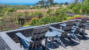 A deck with outdoor seating and a view of the ocean. - Sea Ranch 3BR | Trails, Hot Tub, EV | For 6 (Sea Ranch)