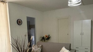Uma sala de estar moderna com um sofá, uma mesa de centro e um lustre.