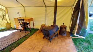 A tent with a wooden table and chairs, a bench, and a small stool. - Trapper Wall Tent, Trapper Wall Tent by the Stream (Story)