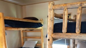 A bunk bed room with wooden frames and blue bedding. - Creekside Chalet, Private Creekside Chalet (Story)