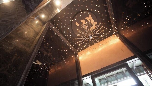 A modern interior with a decorative ceiling light fixture and large windows. - YouJia Apartment (Foshan)