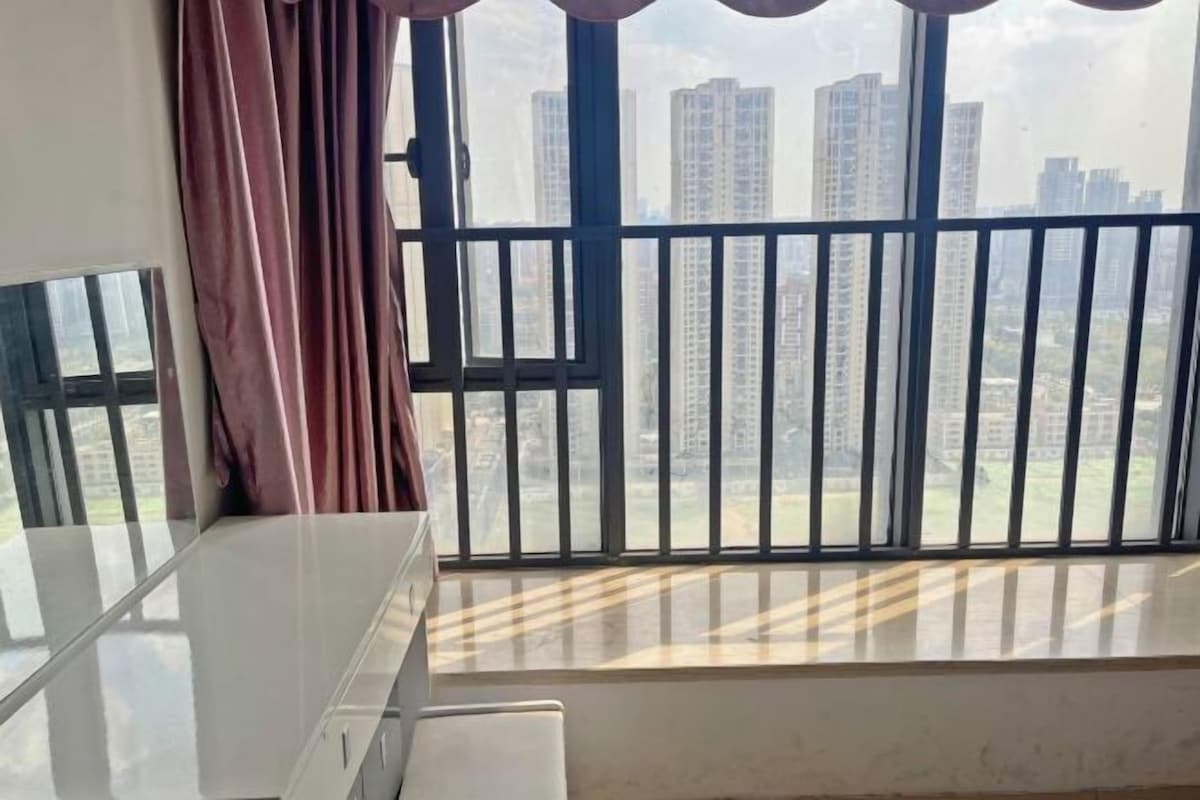 A balcony with a view of high-rise buildings.
