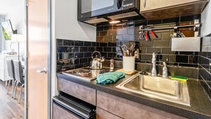 A modern kitchen with a stainless steel sink, a kettle, and a microwave. - Very Cute Studio Next To Ski Slope WiFi Village (Snowshoe)