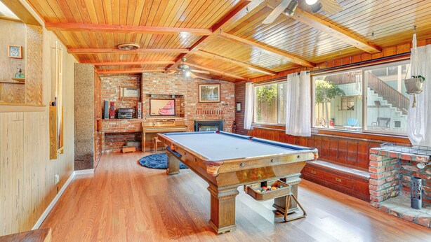 A pool table in a room with wooden ceilings and brick walls. - Burney Cottage w/ Game Room: Walk to Town! (Burney)