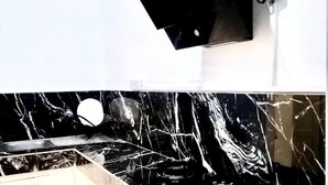 A bathroom with a white wall and a black countertop. - 1 Bed House Private Compound With Off Road Parking (Accra)