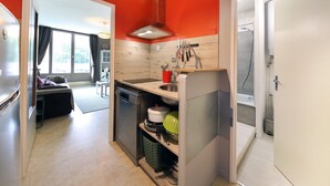 A compact kitchen with a dishwasher, a sink, and a built-in stove.