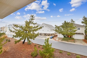 A residential street with houses, a pier, and a clear sky.