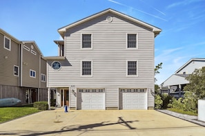 A two-story residential building with a garage, a visible number '137', and a clear sky. - Bayside South Bethany Home (South Bethany)
