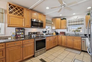Your spacious kitchen comes fully equipped with stainless steel appliances, granite countertops, and all the tools you need to prepare memorable meals during your stay. - The Buffer Zone: Oceanfront Bliss in Bethany Beach (South Bethany)