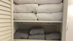 A bathroom with a towel rack holding neatly folded towels in white and gray. - Historic Mill House
 (Lexington)