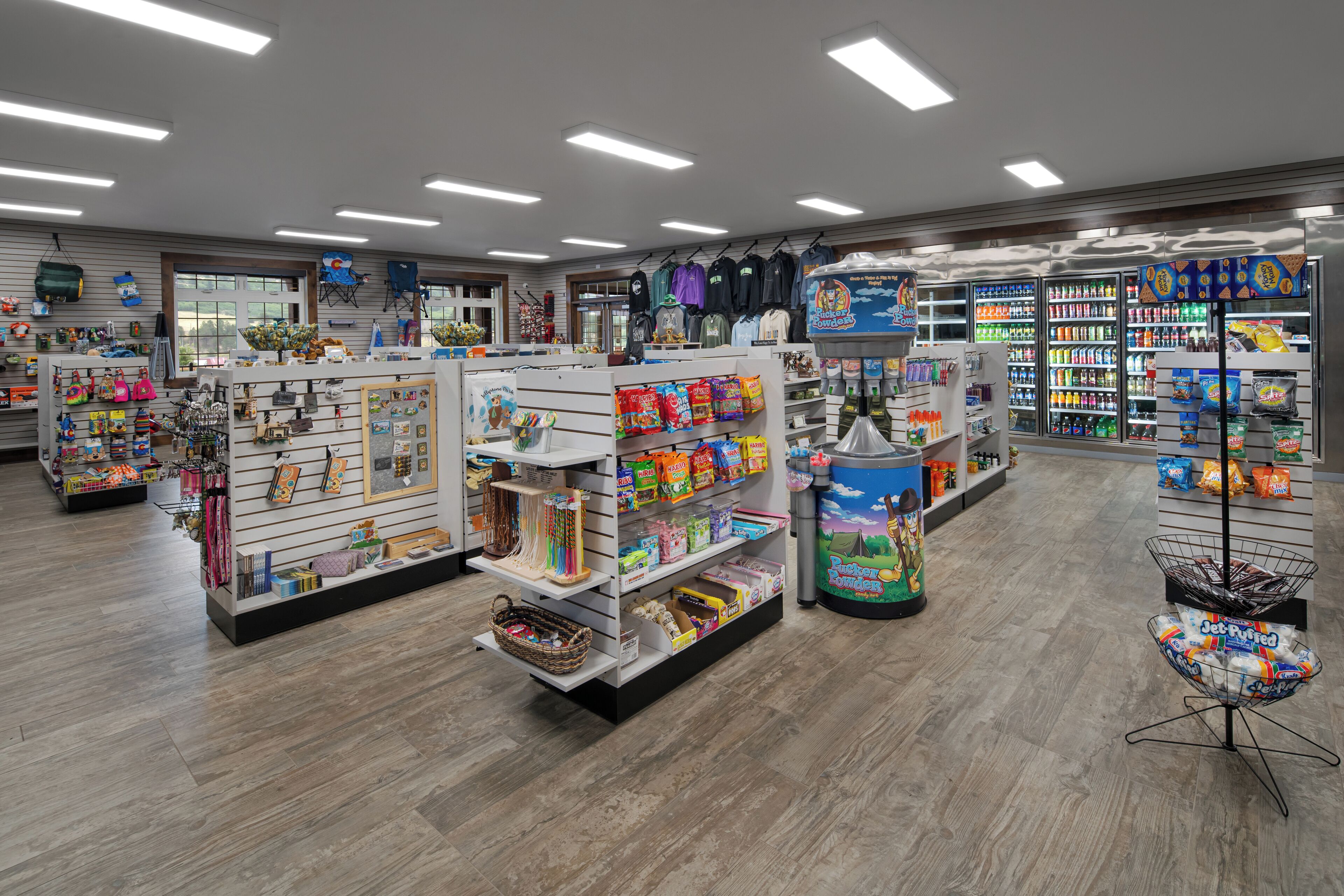 A well-lit store with various shelves stocked with toys, snacks, and other items.