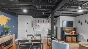 A modern living space with a dining area, kitchen, and entertainment area. - The Sanctuary Spacious 1BR Condo. Stay in Comfort! (Biloxi)