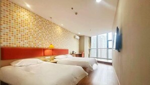 A hotel room with two beds, a red headboard, a yellow lamp, and a large window with a view of buildings. - Homeinn Hotel (Qingdao Zhengyang Middle Road Wanda Plaza) (Qingdao)