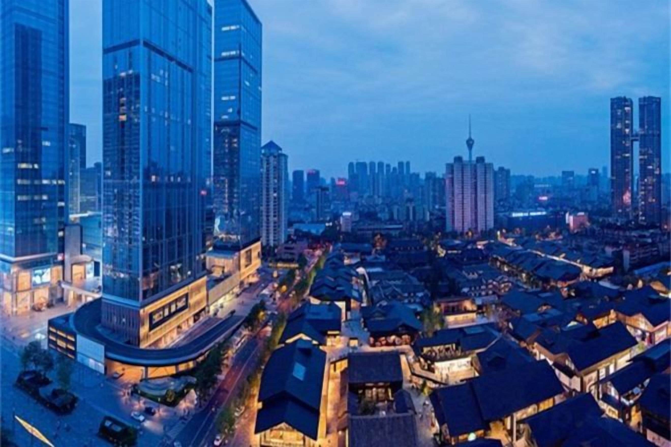 A cityscape with modern high-rise buildings and traditional architecture.