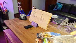 A reception desk with a wooden surface, a check-in counter, and brochures.