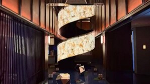 A modern hotel corridor with a curved, illuminated wall feature and a glass floor. - Hangzhou Bay Hotel (Hangzhou)