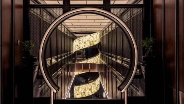 A modern, well-lit interior with a curved, metallic structure and a reflective floor, suggesting a contemporary design. - Hangzhou Bay Hotel (Hangzhou)