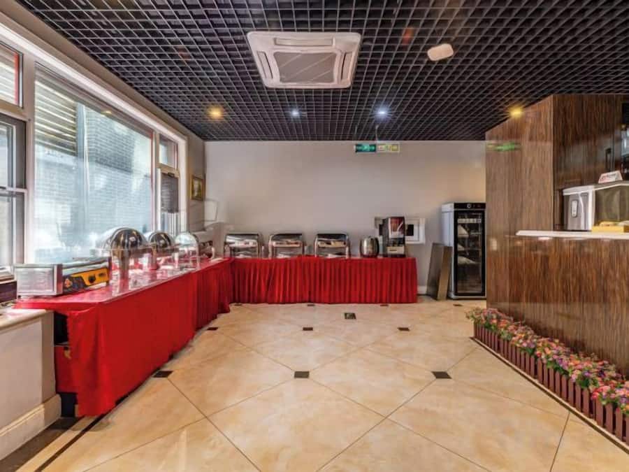 A conference room with a long table, a buffet setup, and a reception desk.
