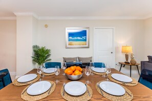 Enjoy meals with family and friends at this dining area, featuring a table set for six and a bowl of fresh fruit.