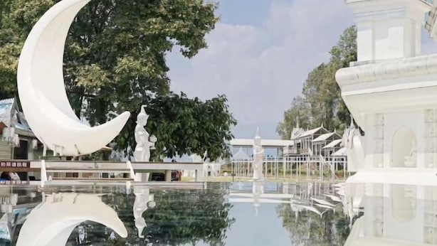 A serene courtyard with a reflective pool, a large moon sculpture, and traditional architecture. - Kyriad Hotel (Mangshi Plaza) (Mangshi)