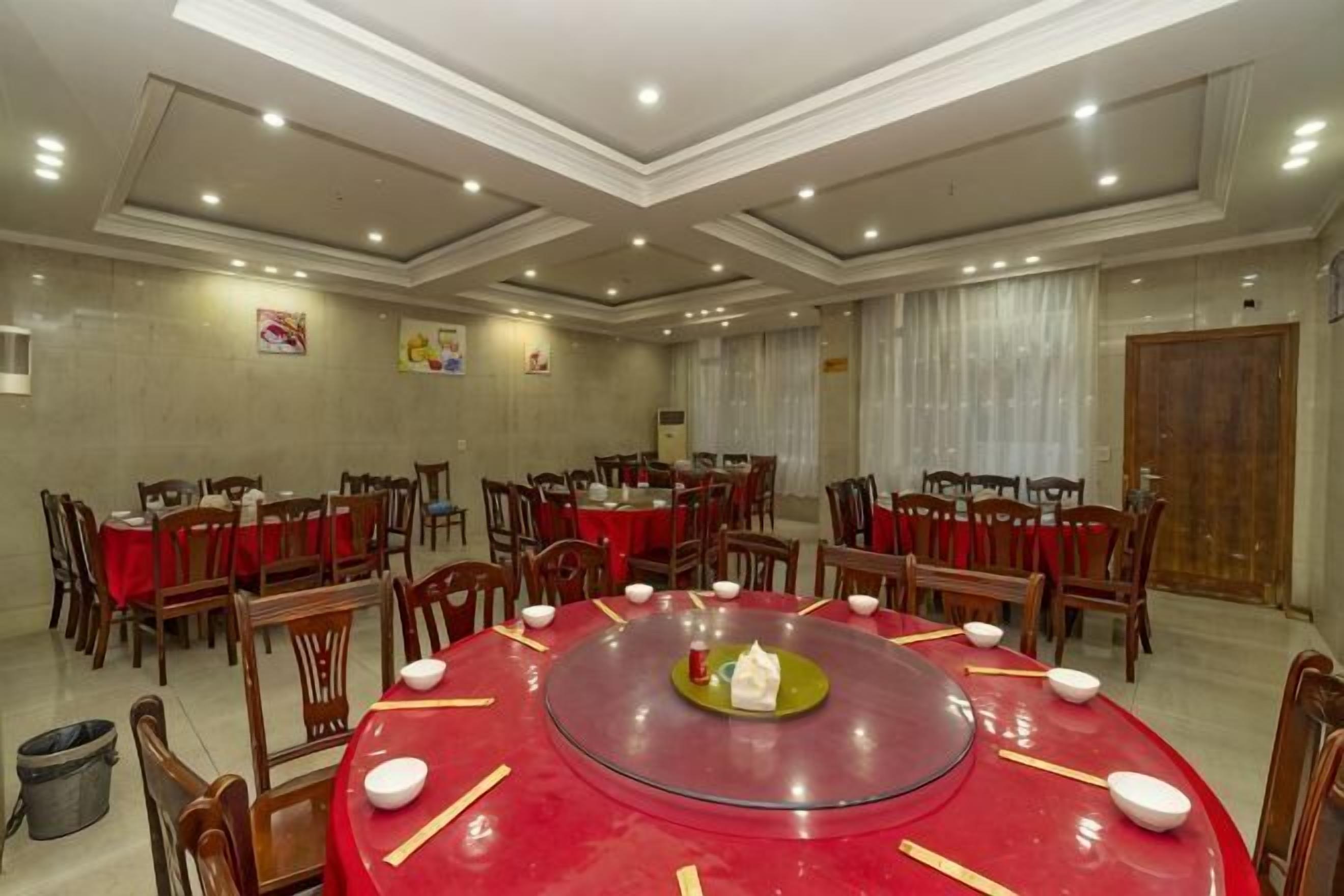 A conference room with round tables, chairs, and a central table with a green tray.