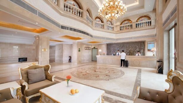 A spacious lobby with a central marble floor, a reception desk, and ornate furniture. - Vienna Hotel (Yangshuo West Street Qianguqing Branch) (Yangshuo)