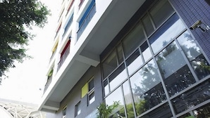 A multi-story building with large windows, a modern architectural style, and a visible balcony. - Micasa Hotel (Taichung)