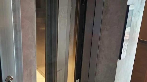 An elevator interior with metallic walls and a door. - Ramos Hello Stay Cebu (Cebu City)