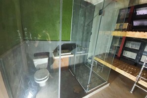 A small, enclosed bathroom with a toilet, shower, and sink. - Ramos Hello Stay Cebu (Cebu City)
