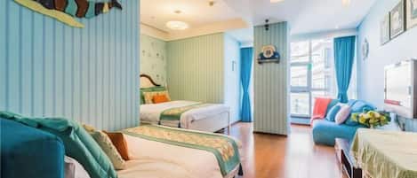 A hotel room with two beds, a sofa, a window with curtains, and a wall-mounted decoration.