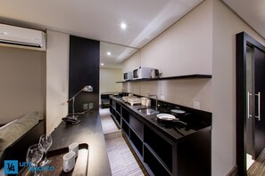 Een microgolfoven, een waterkoker, kookgerei, borden en bestek