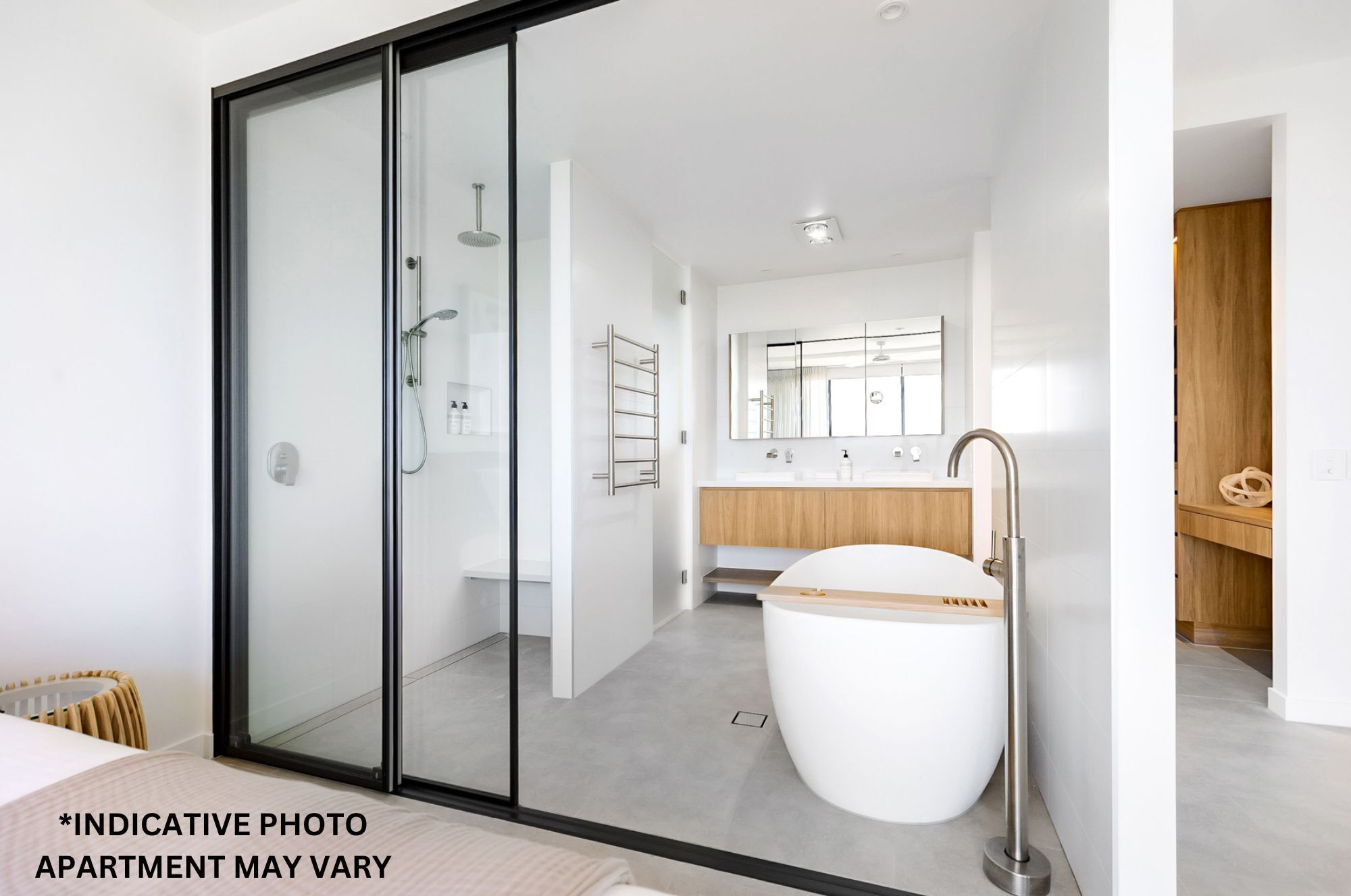 A modern bathroom with a glass shower enclosure, a freestanding bathtub, and a wooden vanity.