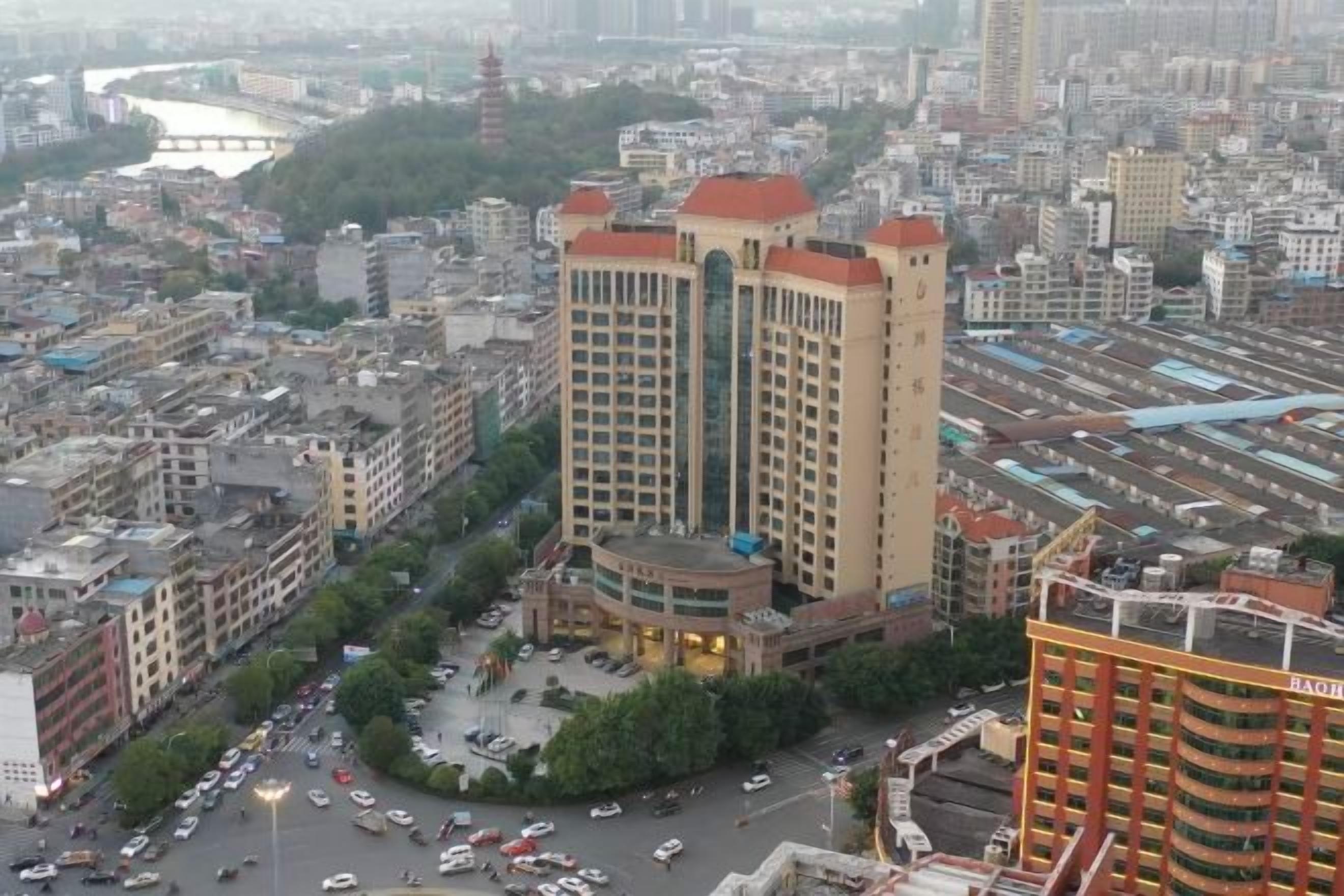 A high-rise building with a central courtyard surrounded by smaller structures.